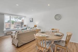 a living room with a table and a couch at Grove Avenue in Norwich