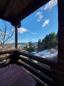 a view from the porch of a log cabin with a view at Paradise Chalet in Ano Trikala