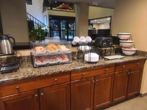 a buffet in a hotel room with food on a counter at Comfort Inn & Suites Leeds I-20 in Leeds
