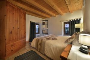 a bedroom with a large bed and a table at Albergo Casa Alpina San Luigi in Campodolcino +55 photos