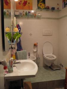 a bathroom with a white sink and a toilet at Appartamento con incantevole vista mare in Livorno