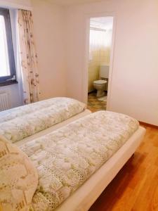 Voodi või voodid majutusasutuse Hotel Gemmi toas