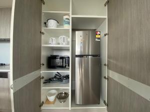a kitchen with a stainless steel refrigerator in a pantry at Nintendo Theme-Adelaide CBD-King Bed-Spa-Gym-BBQ in Adelaide