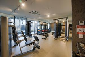 a gym with treadmills and machines in a building at Nintendo Theme-Adelaide CBD-King Bed-Spa-Gym-BBQ in Adelaide