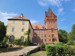 a large brick building with a tower on top of it at Wohnung Waltraud in Plattenburg