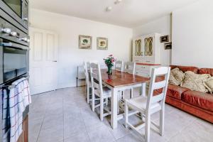 a kitchen and dining room with a table and chairs at 2 Victoria Street in Armagh