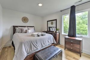 a bedroom with a large bed and a window at Contemporary Raleigh Home about 2 Mi to Downtown! in Raleigh