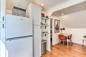 a kitchen with a white refrigerator and a table at Chic, Treetop Denver Apt about 2 Mi to Downtown! in Denver
