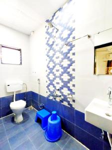 a bathroom with a toilet and a sink at Hotel United House in Shirdi