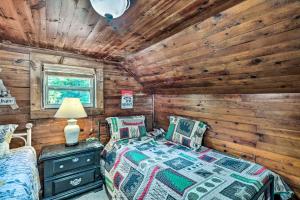 a bedroom with a bed in a log cabin at Cozy Ennice Cabin on the Blue Ridge Parkway! in Glade Valley