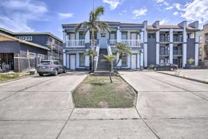 a blue building with palm trees in front of it at South Padre Island Condo - 200 Ft to Beach! in South Padre Island