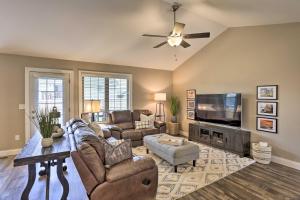 a living room with couches and a flat screen tv at Rapid City Home with Patio Less Than 5 Mi to Downtown! in Rapid City