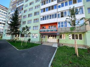an apartment building with a parking lot in front of it at Muntean Residence in Sibiu