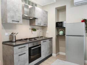 a kitchen with stainless steel appliances and a refrigerator at DOMUS LINGOTTO in Turin