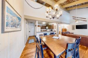 a dining room and kitchen with a wooden table and chairs at Mammoth Ski & Racquet 30 in Mammoth Lakes