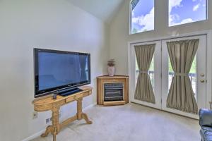 a living room with a flat screen tv on a table at Secluded Mountain City Home with Deck and Views! in Mountain City