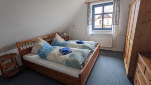 Postel nebo postele na pokoji v ubytování Ferienhaus Arkona Putgarten