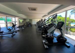 a gym with a row of treadmills and elliptical machines at Apartamento Le Club Acapulco in Acapulco