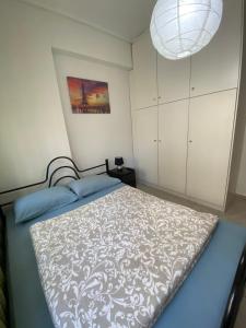 a bedroom with a bed and a chandelier at Central Apartment Thessaloniki-Easy Parking in Thessaloniki