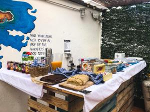 a table topped with a variety of food items at Arena Nest Hostel in Puerto de Santiago