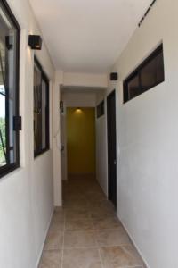 a hallway with white walls and a green wall at Casa Monarca in Oaxaca City