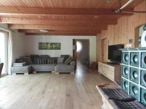 a living room with a couch and a tv at Das Grasberghaus in Grasberg