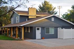 a blue house with a driveway in front of it at Central Kanab Apartment with Updated Interior! in Kanab