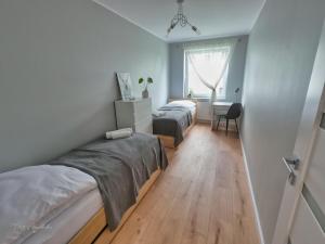 Posteľ alebo postele v izbe v ubytovaní Apartament Honoratka