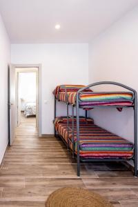 a hallway with three bunk beds in a room at Villa mi Pequeña Alba in Barbate