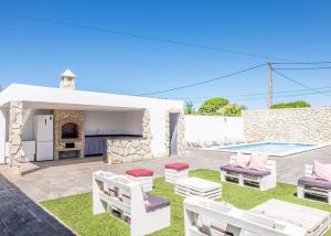 a villa with a patio and a swimming pool at Villa Castillo de Alba in Barbate