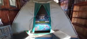 a bed in a tent in a room at Protea Lodge - Glamping in the Karoo in Barrydale