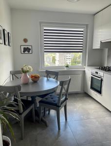 a kitchen with a table and chairs and a window at panoramic view and free parking in Vilnius