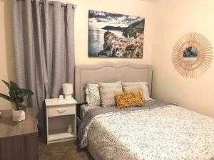 a bedroom with a bed and a painting on the wall at * Radiant Retreat * King Bed * Long Term Stays * in Durham