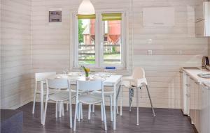 a white dining room with a white table and chairs at Awesome Home In Rewal With Wifi in Rewal