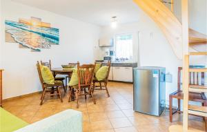 a kitchen and dining room with a table and chairs at Dom Szeregowy in Darłowo