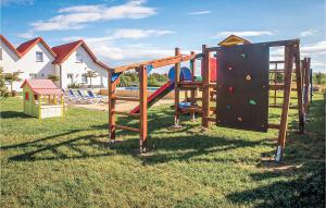 a playground with a slide in the grass at Dom Szeregowy in Darłowo