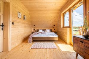 a bedroom with a bed in a wooden room at Willa Tritri 1 Butikowy dom wakacyjny in Witów +51 photos