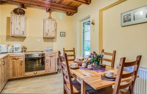 a kitchen with a wooden table and a table and chairs at Amazing Home In Pobierowo With 2 Bedrooms And Wifi in Pobierowo
