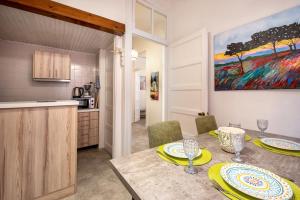 a kitchen and dining room with a table and chairs at JoMi House of Art, Old Corfu Town in Corfu Town