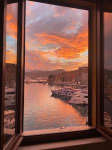 a window view of a harbor with boats in the water at Le Stanze sul Mare in Portoferraio