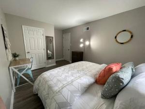 a bedroom with two beds and a mirror on the wall at * Durham Diggs * Pet Friendly * King Bed * in Durham