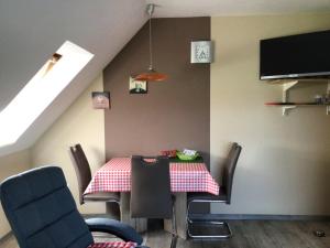 a dining room with a table and chairs at Nordseekrabbe Bollmann in Carolinensiel