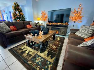 a living room with couches and a christmas tree at Riverchase Lodge in Pigeon Forge