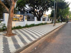 a sidewalk with a sign on the side of a street at Chic Guest House & Solar system free from load shedding in Germiston