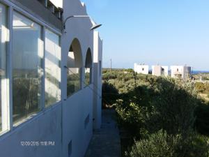 a view from the side of a house with the city in the background at Elafonisi Vacation Green Studio in Agios Padeleimon