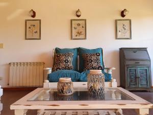 a living room with a blue couch and a table at Encanto del Rio in Villa La Angostura