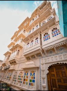 a building with a lot of windows on it at Royal Rafahiya Haveli - LAKE FACING in Udaipur