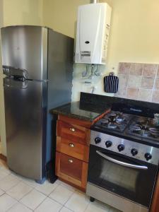 a kitchen with a stainless steel refrigerator and a stove at La Morada, imperdible Casa de Campo en La Matilde in San Javier