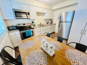 a kitchen with a wooden table with skulls on it at *Prime Pad * King Bed * Long Term Stays* in Durham