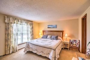 a bedroom with a large bed and a window at Finger Lakes Retreat with Sunroom, Fire Pit and BBQ! in Himrod